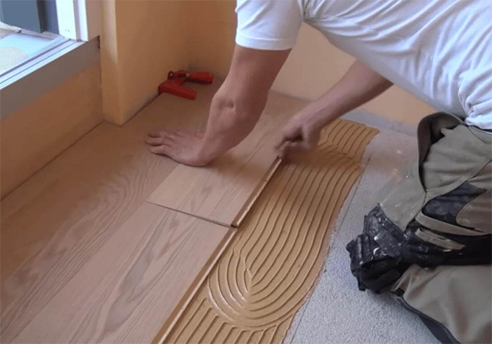 Hardwood flooring installation laying the flooring